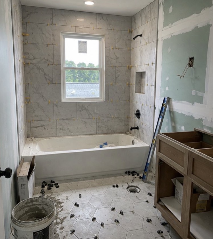 Bathroom mid-renovation with marble tiled shower surround